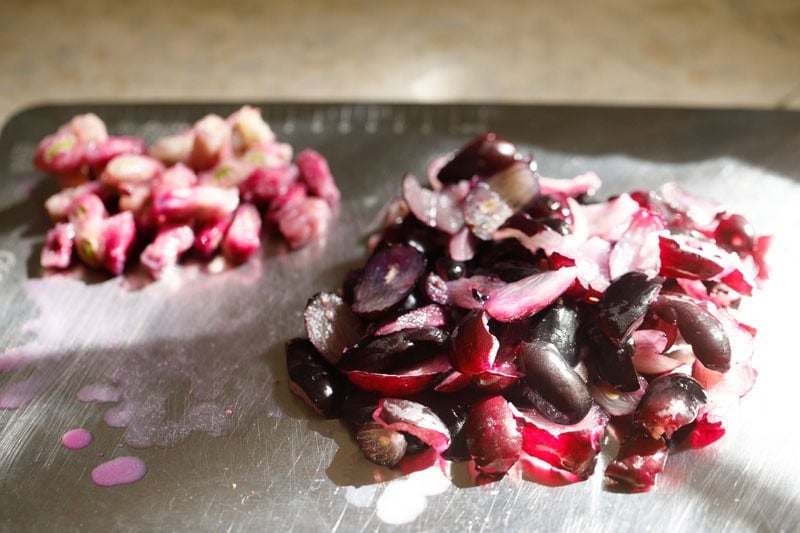 Chopped jamuns with seeds at the side.