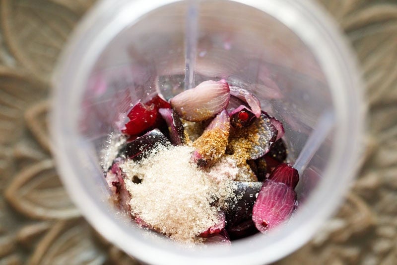 Chopped jamuns, sugar and spices in a blender.