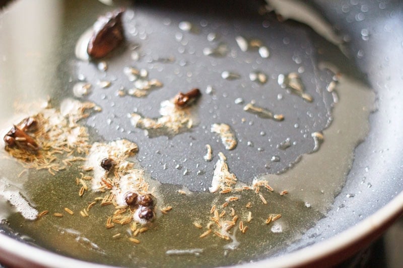 whole spices spluttering in oil.