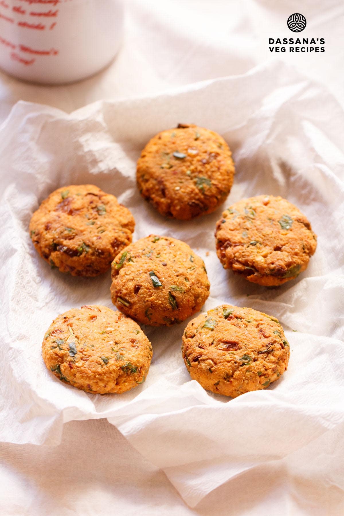Masala vada on a plate lined with kitchen paper.