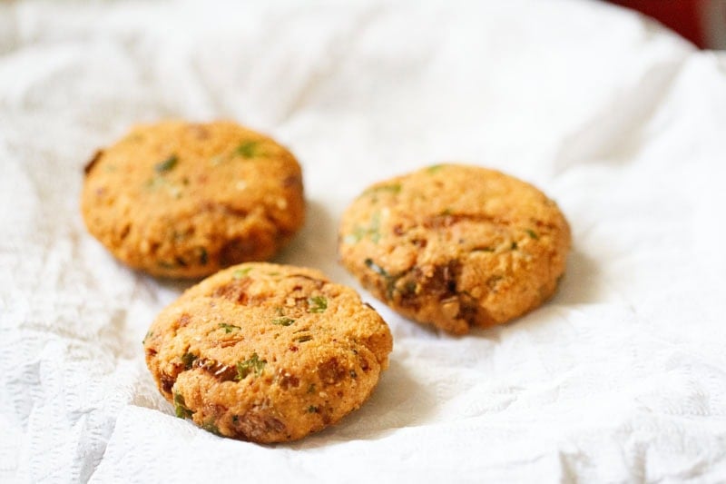 Crispy golden fried masala vada on kitchen paper towels.
