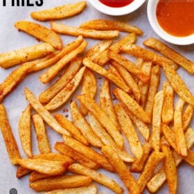 Spicy, homemade peri peri fries with dips on side.