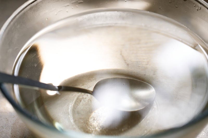 Bowl with a spoon and water.