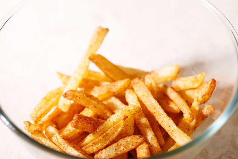 Fries mixed evenly with peri peri spice mix to make peri peri fries.
