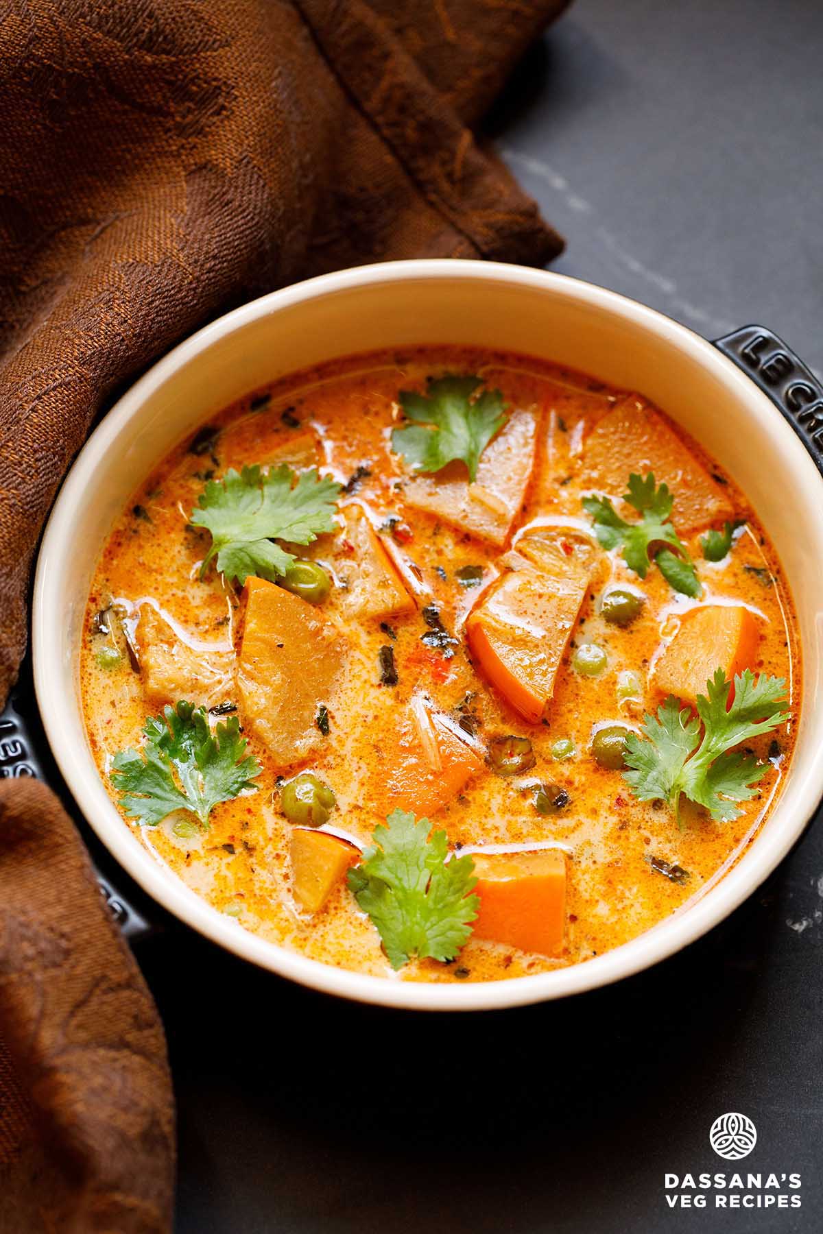 Creamy pumpkin curry with coriander garnish.