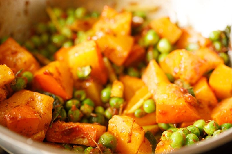 Pumpkin, pea eggplants and green peas mixed with red curry paste and oil mixture.