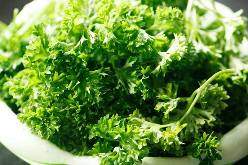 Rinsed parsley in strainer.