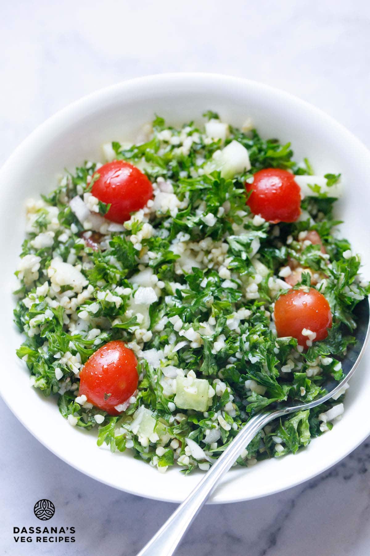Fresh tabouli salad with tomatoes in a bowl.