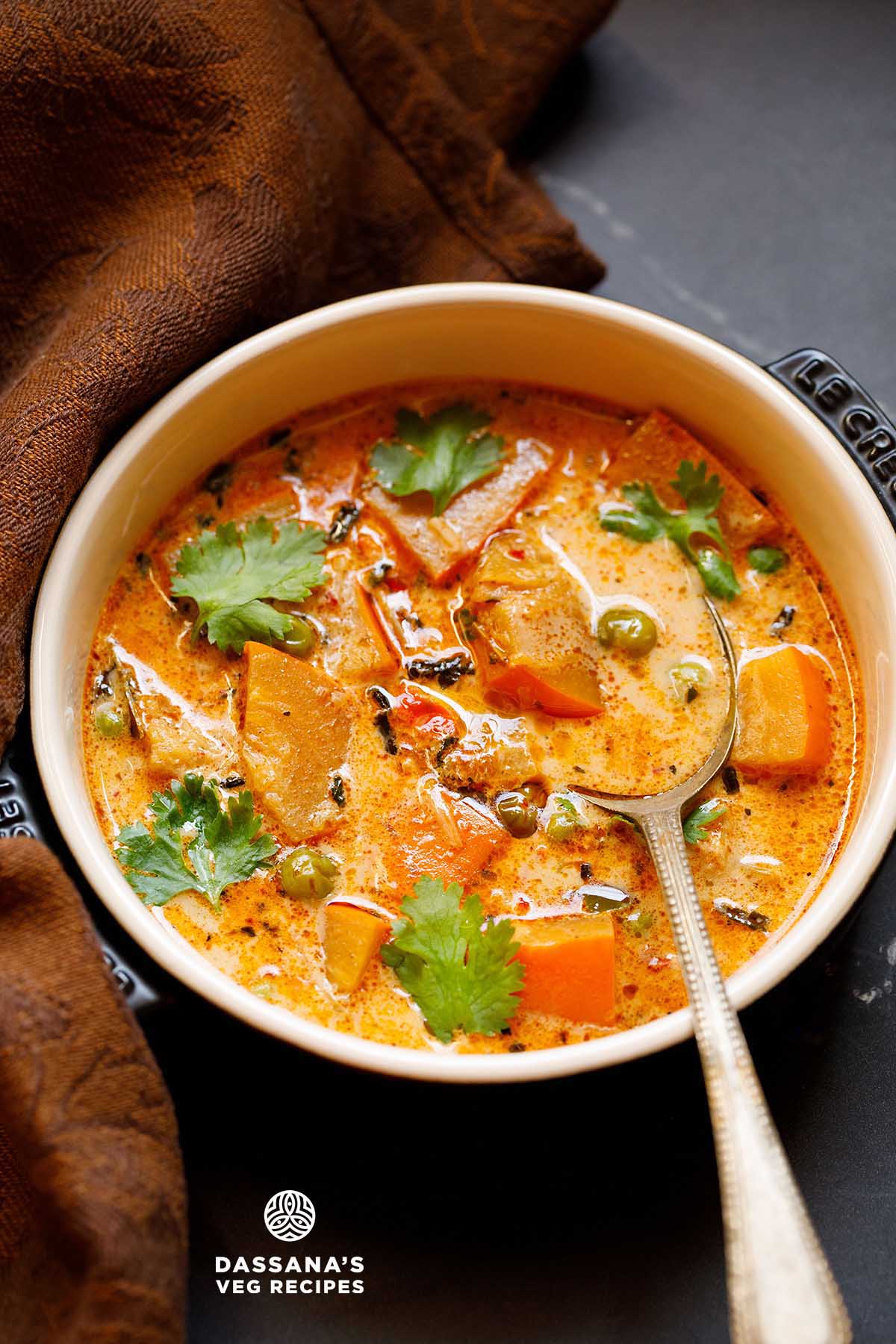 Thai pumpkin curry in a bowl with spoon.