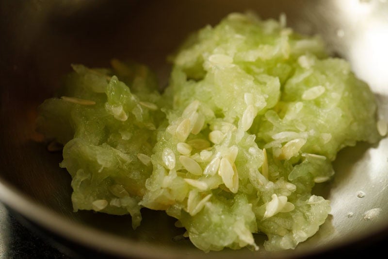 grated and squeezed cucumber in mixing bowl.