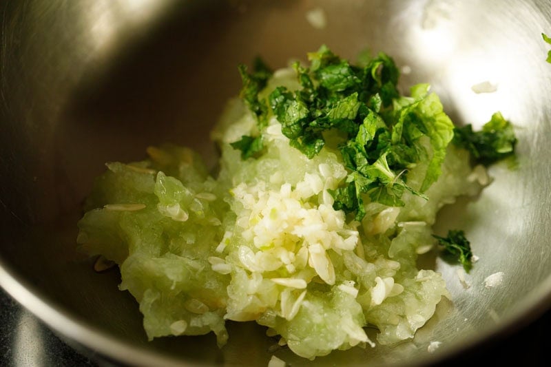 mint, garlic and cucumber in bowl.