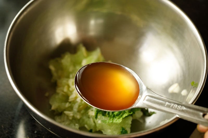 apple cider vinegar in measuring spoon.