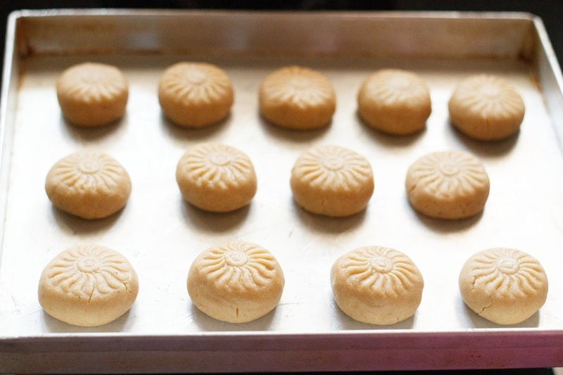 Wheat cookies with design on them on baking tray.