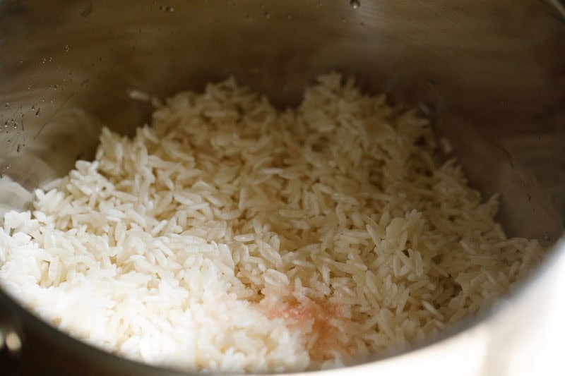 Jasmine rice and salt in a pan.