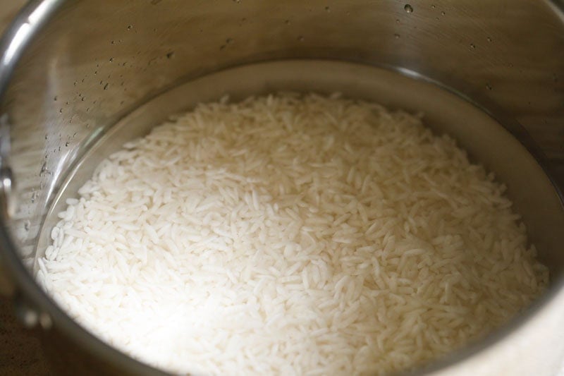 Water and jasmine rice in a pan.
