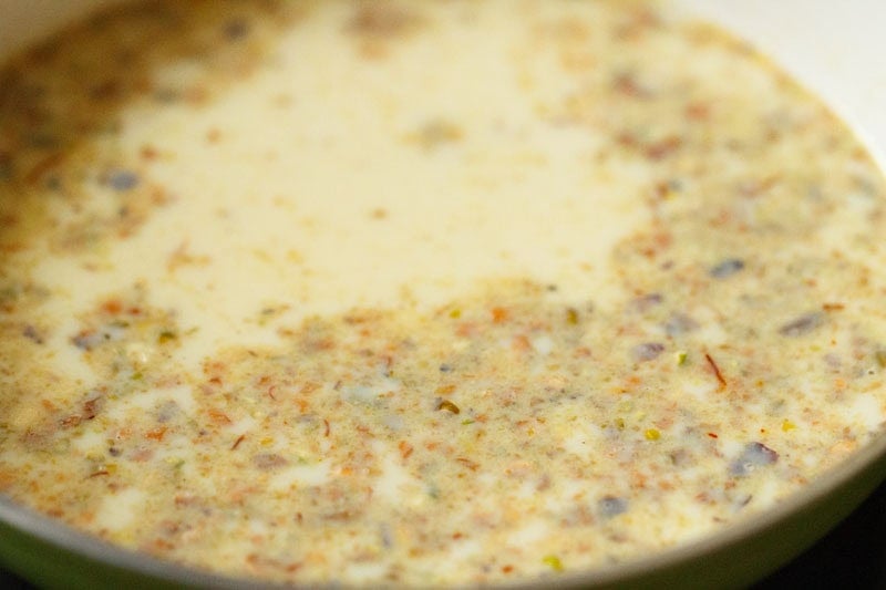 Heating saffron infused milk in pan to make saffron falooda.
