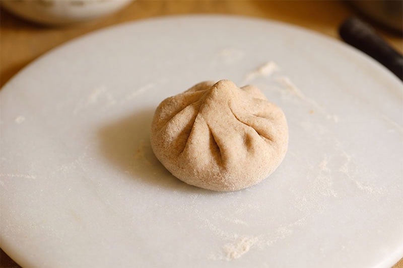 Neatly folded dough with sattu filling.