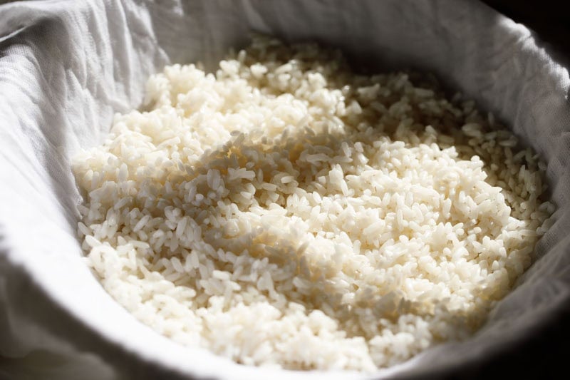 Sticky rice spread over muslin on a steamer.