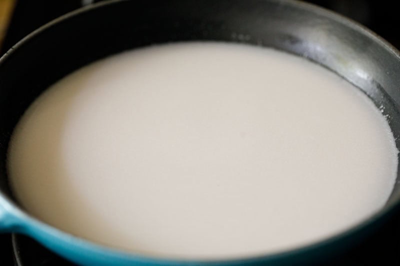 Coconut milk in a skillet.