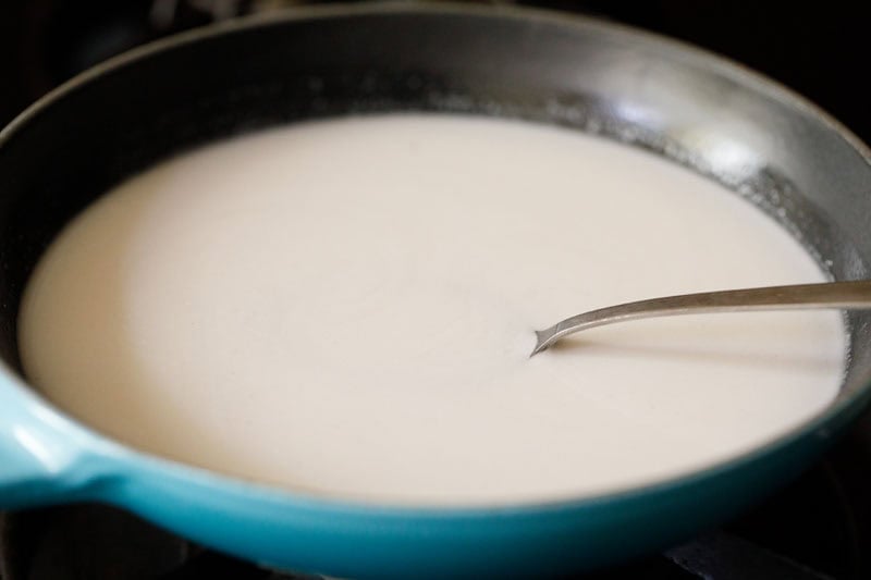 Sugar being mixed with coconut milk.