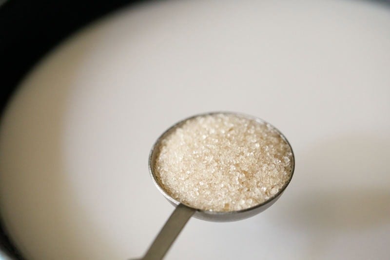 Sugar in a measuring spoon.