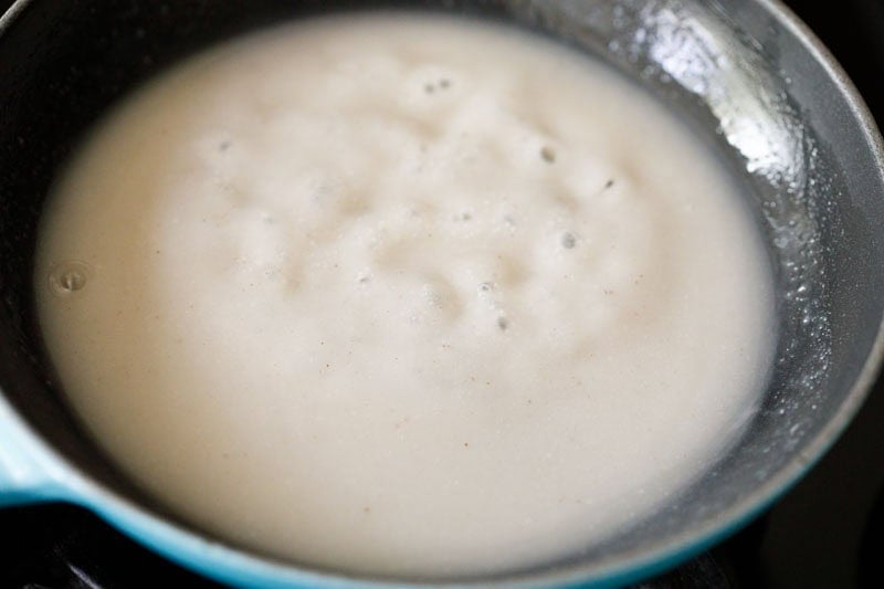 Coconut sauce simmering in skillet.