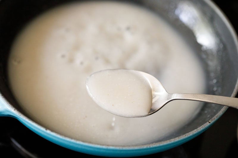 Spoon with coconut sauce.