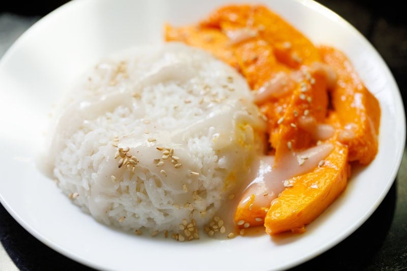 Assembled mango sticky rice pudding on plate.