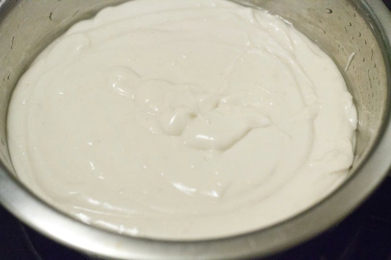 Evenly mixed rice dosa batter kept to ferment in a bowl.