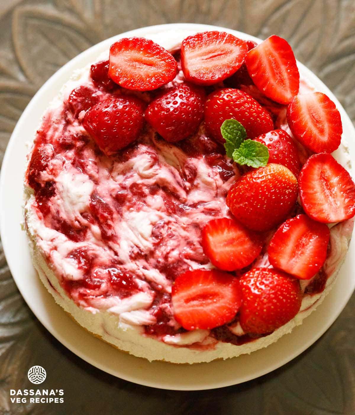 Overhead shot of strawberry cheesecake with top swirls and a marbled effect.