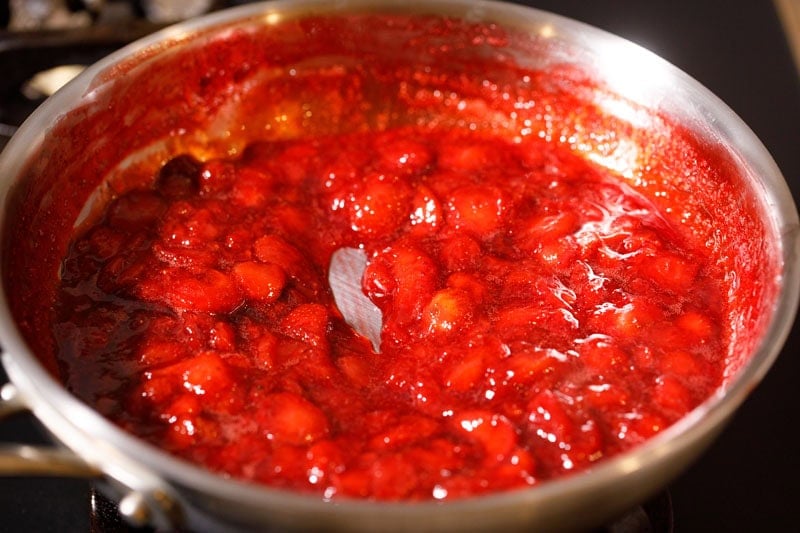 Thick strawberry coulis in pan.