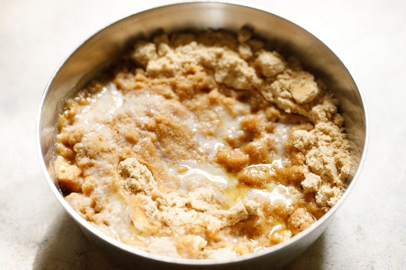 Powdered cookies with melted butter in bowl.