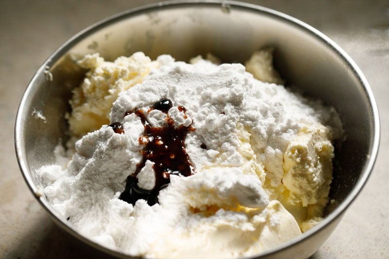 Cream cheese, vanilla and powdered sugar in mixing bowl.