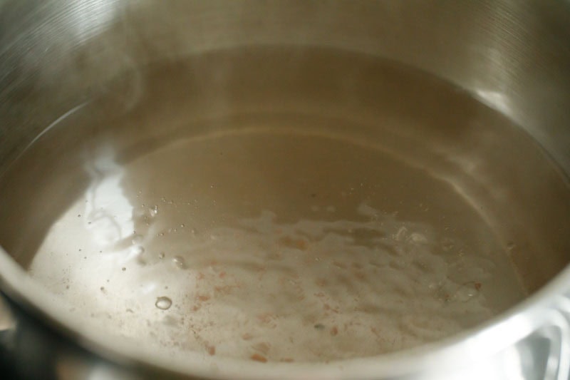 Water seasoned with salt boiling in a pan.