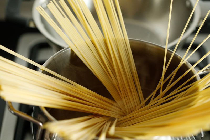 Uncooked spaghetti in a pot.