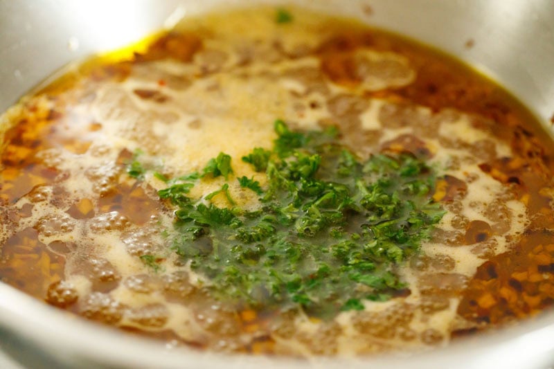 Oil with parsley and spices bubbling.