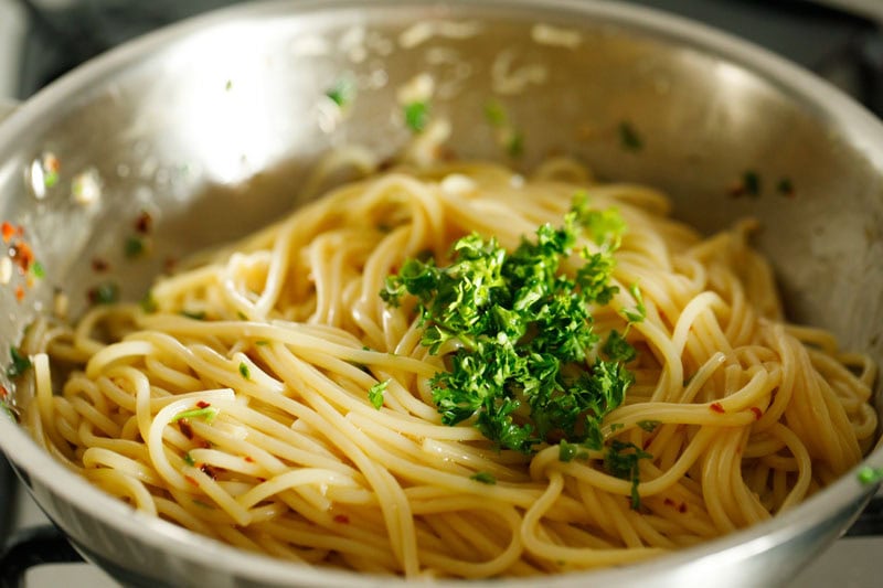 Prepared spaghetti aglio e olio with parsley garnish.
