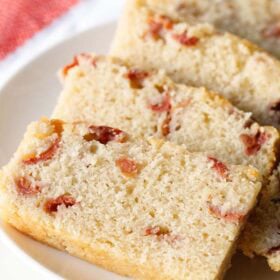 Cherry cake slices on a white plate.