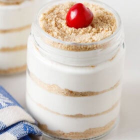 Layered Serradura dessert with cherry on top.