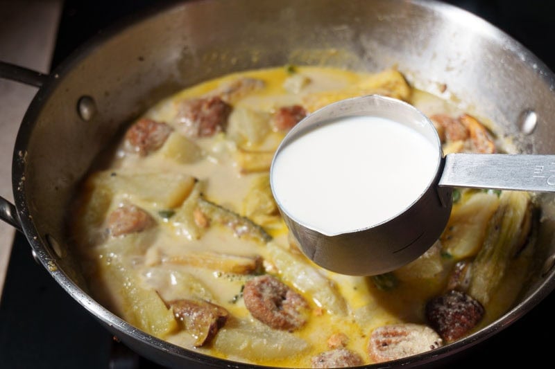 Cooking shukto with vegetables and milk